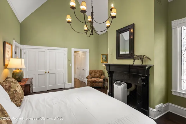 a bedroom with a bed and dresser with mirror