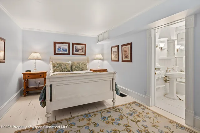 a bedroom with a bed and a mirror