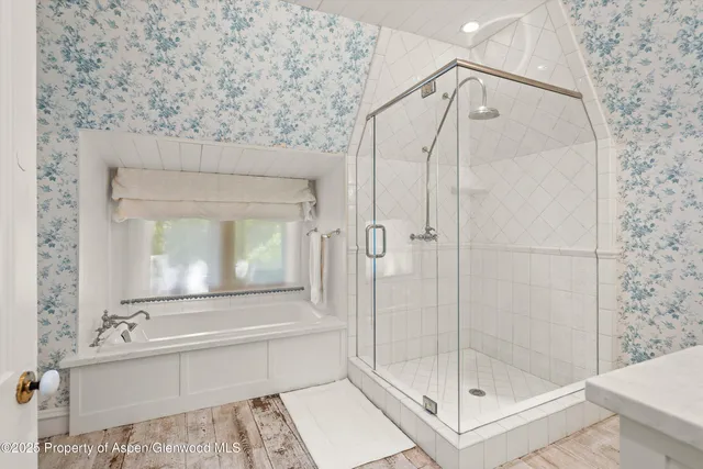 a bathroom with a shower and a mirror