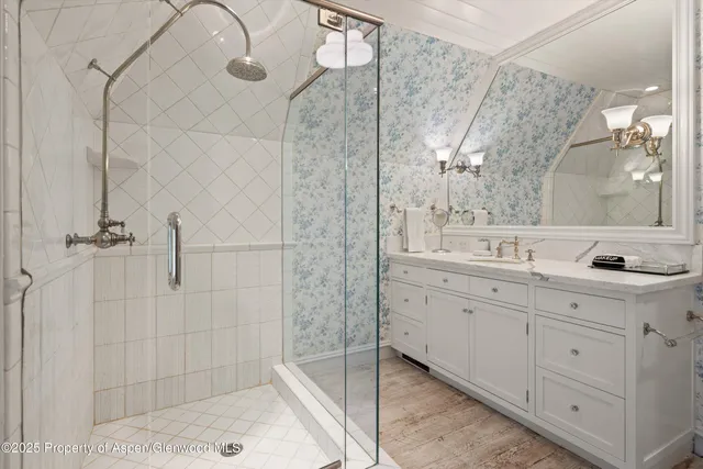 a bathroom with a double vanity sink mirror and shower