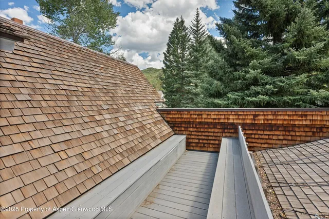 a view of balcony with wooden floor and fence