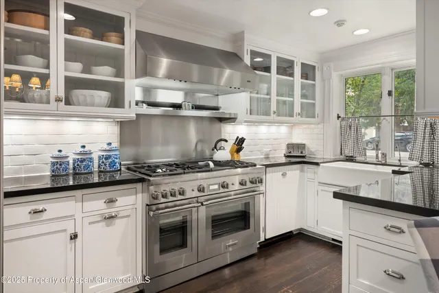 a kitchen with stainless steel appliances granite countertop a stove and a sink