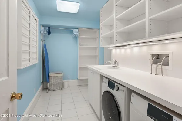 a utility room with cabinets dryer and washer