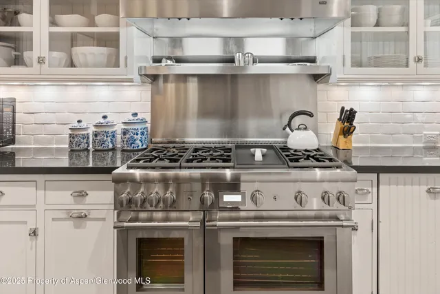 a stove top oven sitting inside of a kitchen