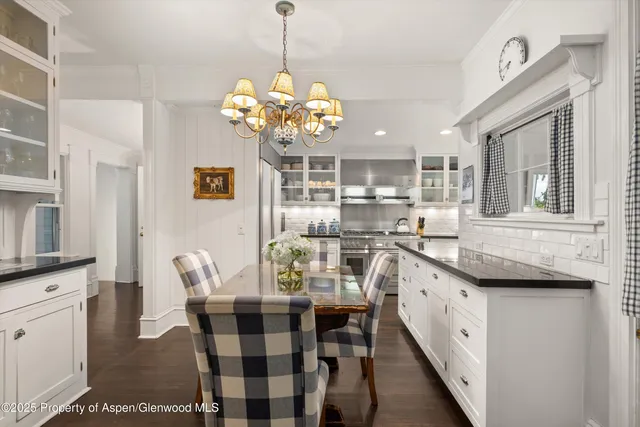 a view of a dining room with furniture and chandelier
