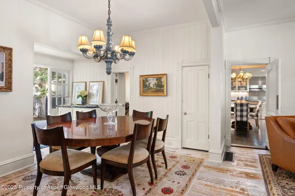 a view of a dining room with furniture and chandelier
