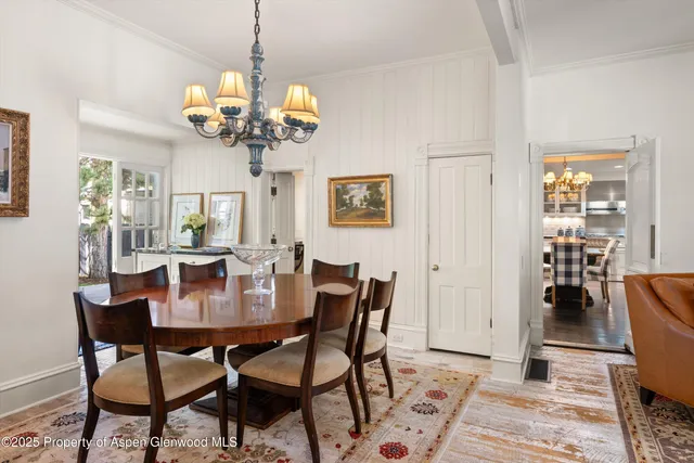 a view of a dining room with furniture and chandelier