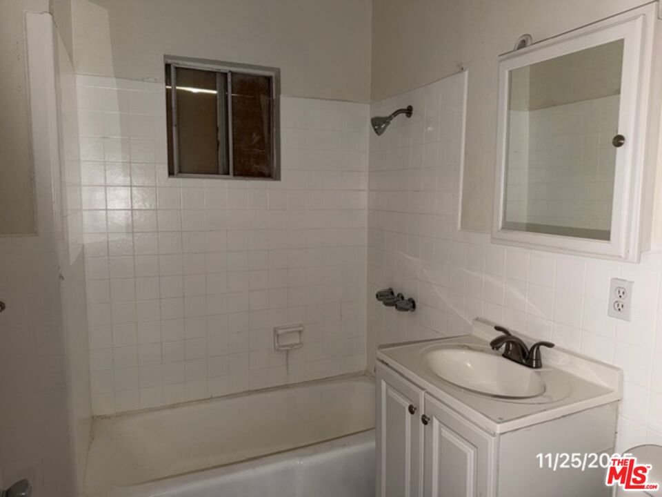 1740 South Rimpau Boulevard Los Angeles, CA 90019 - Photo 11 of 18 a bathroom with a sink and a shower