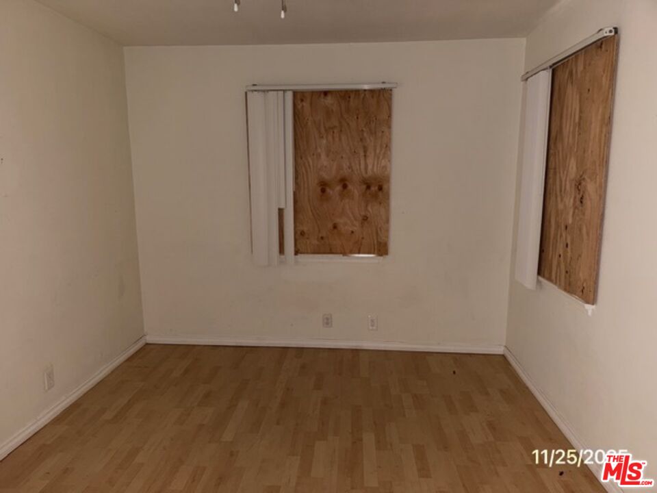 1740 South Rimpau Boulevard Los Angeles, CA 90019 - Photo 15 of 18 an empty room with a wooden door