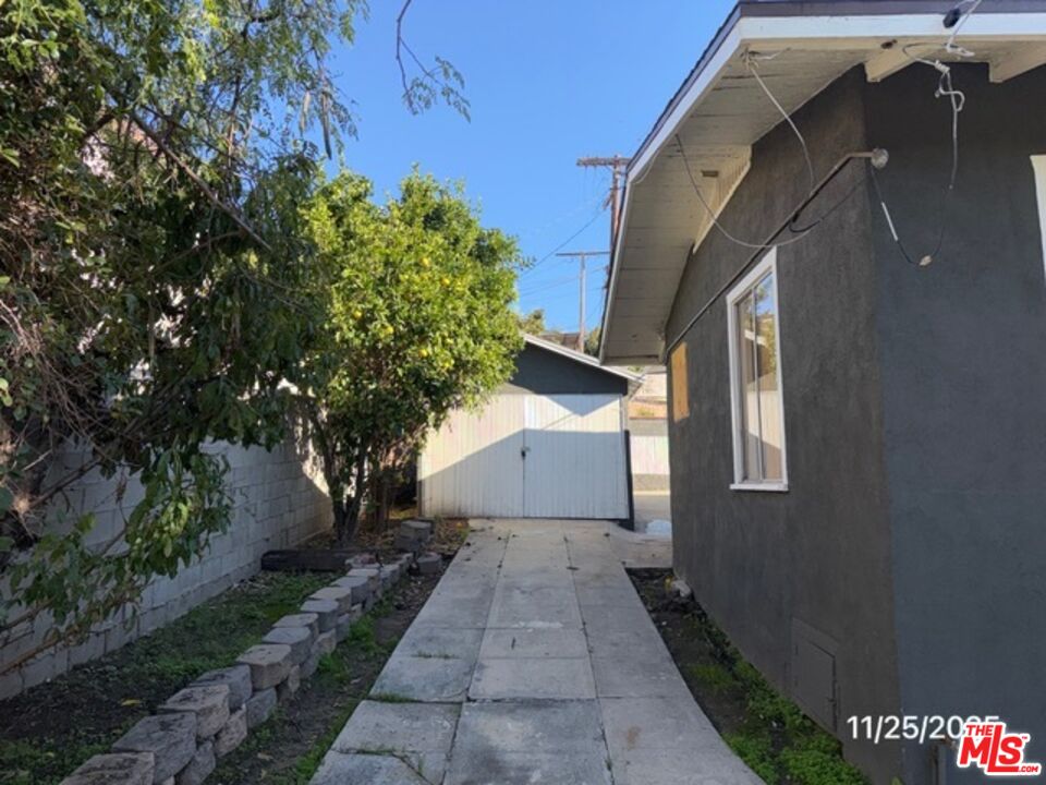 1740 South Rimpau Boulevard Los Angeles, CA 90019 - Photo 2 of 18 a view of a house with a yard