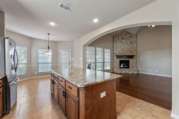 a kitchen with stainless steel appliances granite countertop a sink and a refrigerator