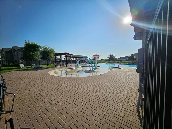 a view of a swimming pool and a yard