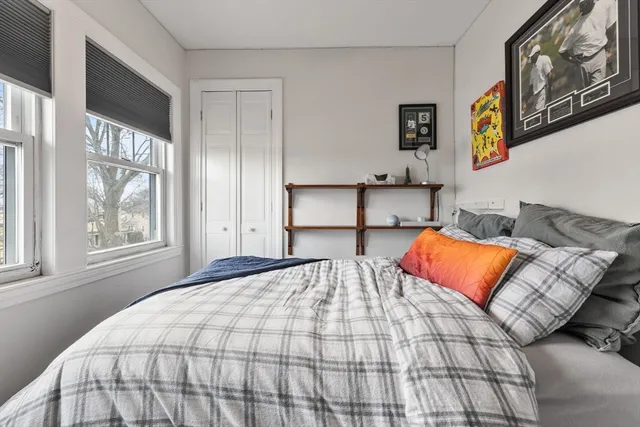 a bedroom with a bed and window