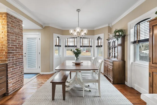 a view of a dining room with furniture window and wooden floor
