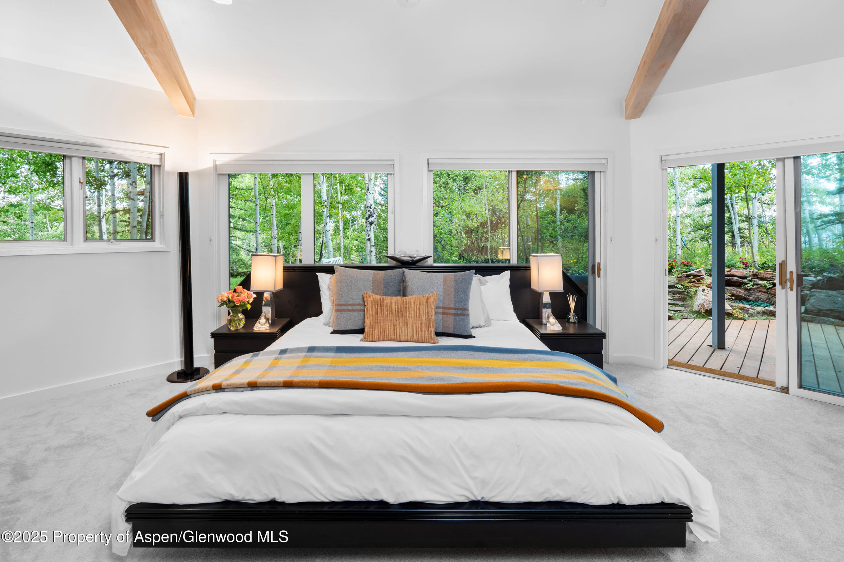 239 Antler Ridge Lane Snowmass Village, CO 81615 - Photo 17 of 50 a bed sitting in a bedroom next to a large window