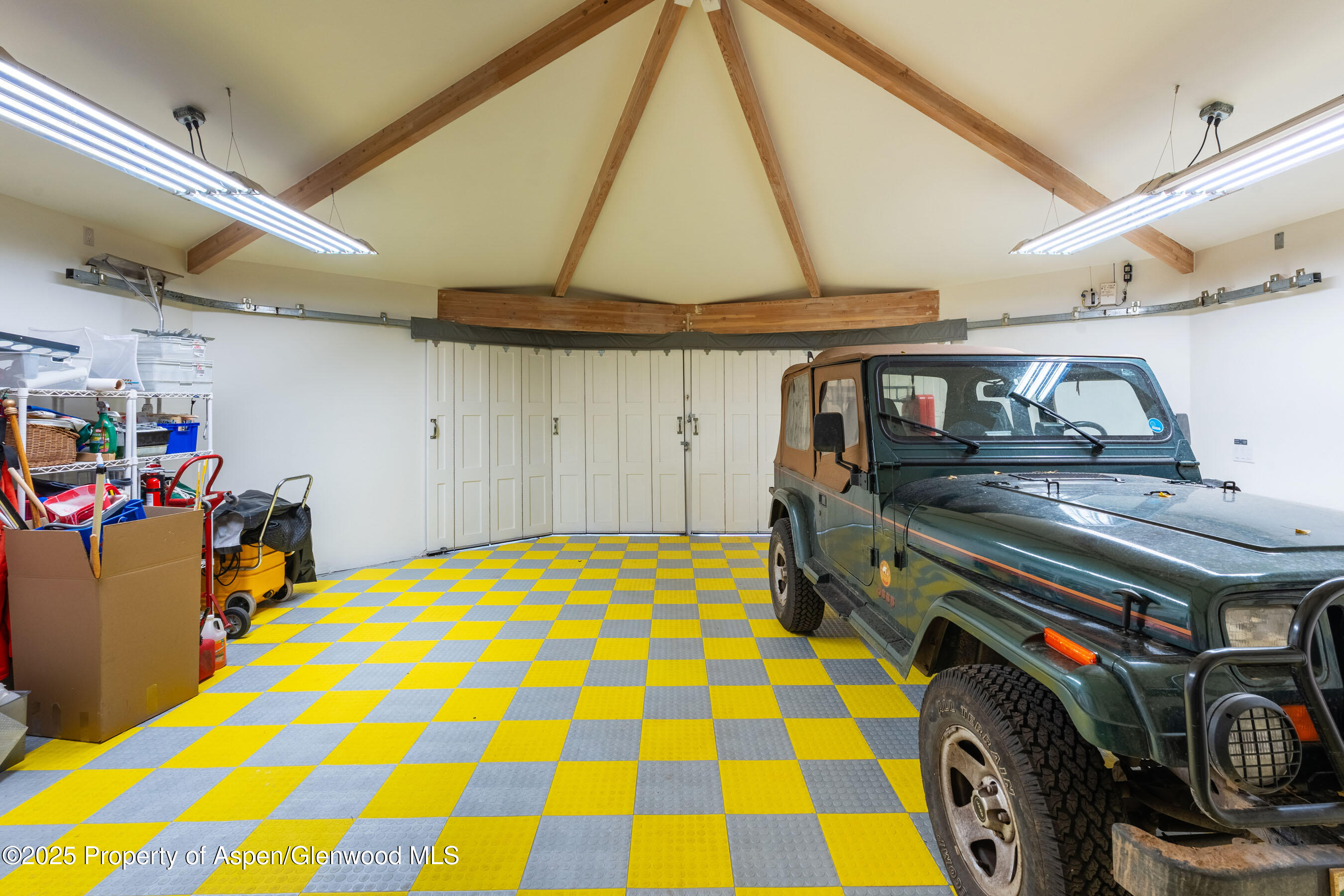 239 Antler Ridge Lane Snowmass Village, CO 81615 - Photo 42 of 50 a bedroom with a bed and a chandelier
