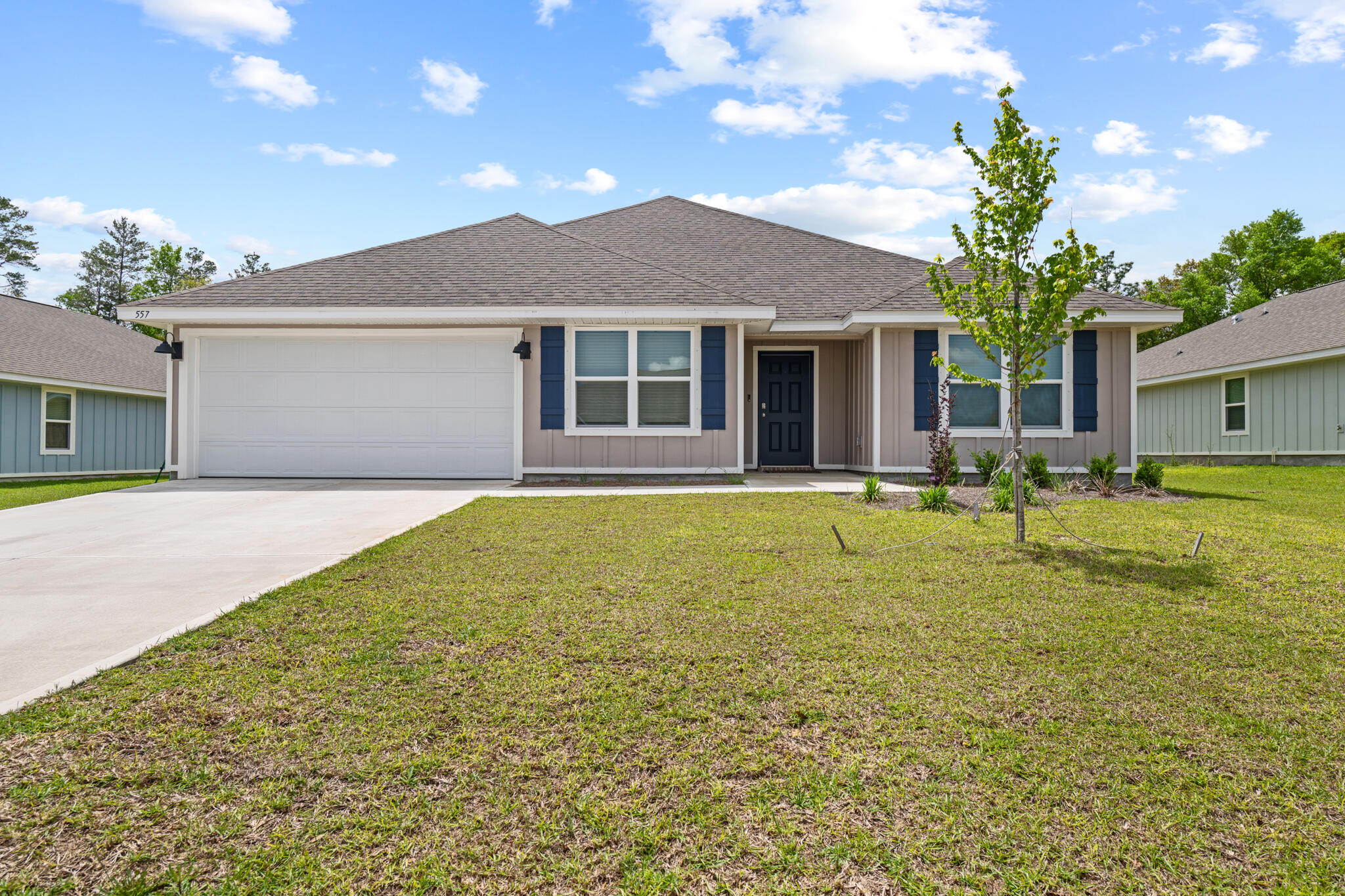 557 Mary Lou Way Crestview, FL 32539 - Photo 1 of 11 a front view of house with yard and trees in the background
