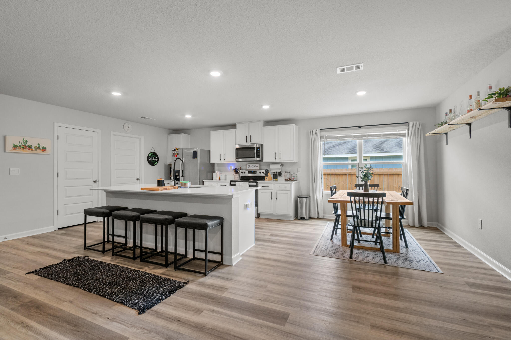 557 Mary Lou Way Crestview, FL 32539 - Photo 4 of 11 a view of a dining room with furniture window and wooden floor