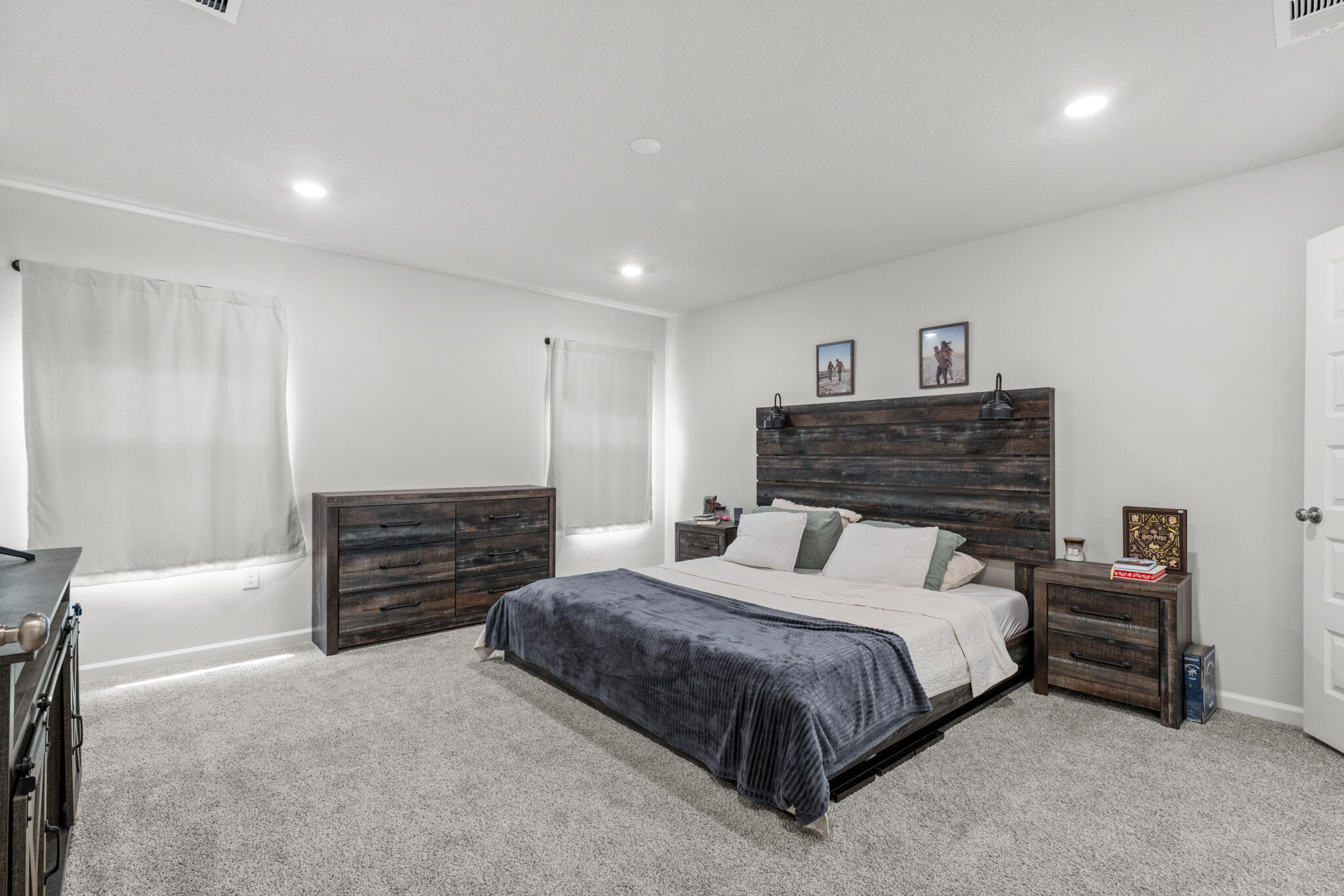 557 Mary Lou Way Crestview, FL 32539 - Photo 5 of 11 a spacious bedroom with a bed and a cabinets