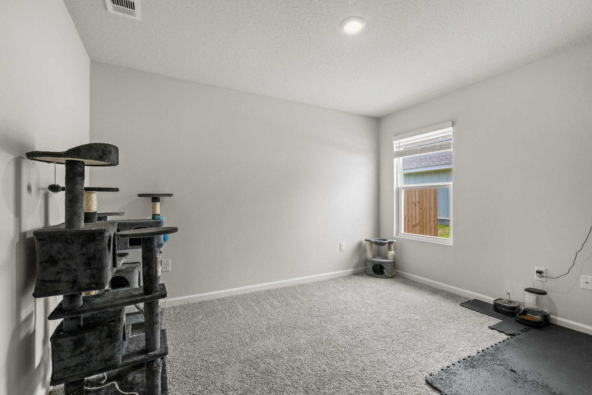 557 Mary Lou Way Crestview, FL 32539 - Photo 8 of 11 a room with gym equipment and wooden floor