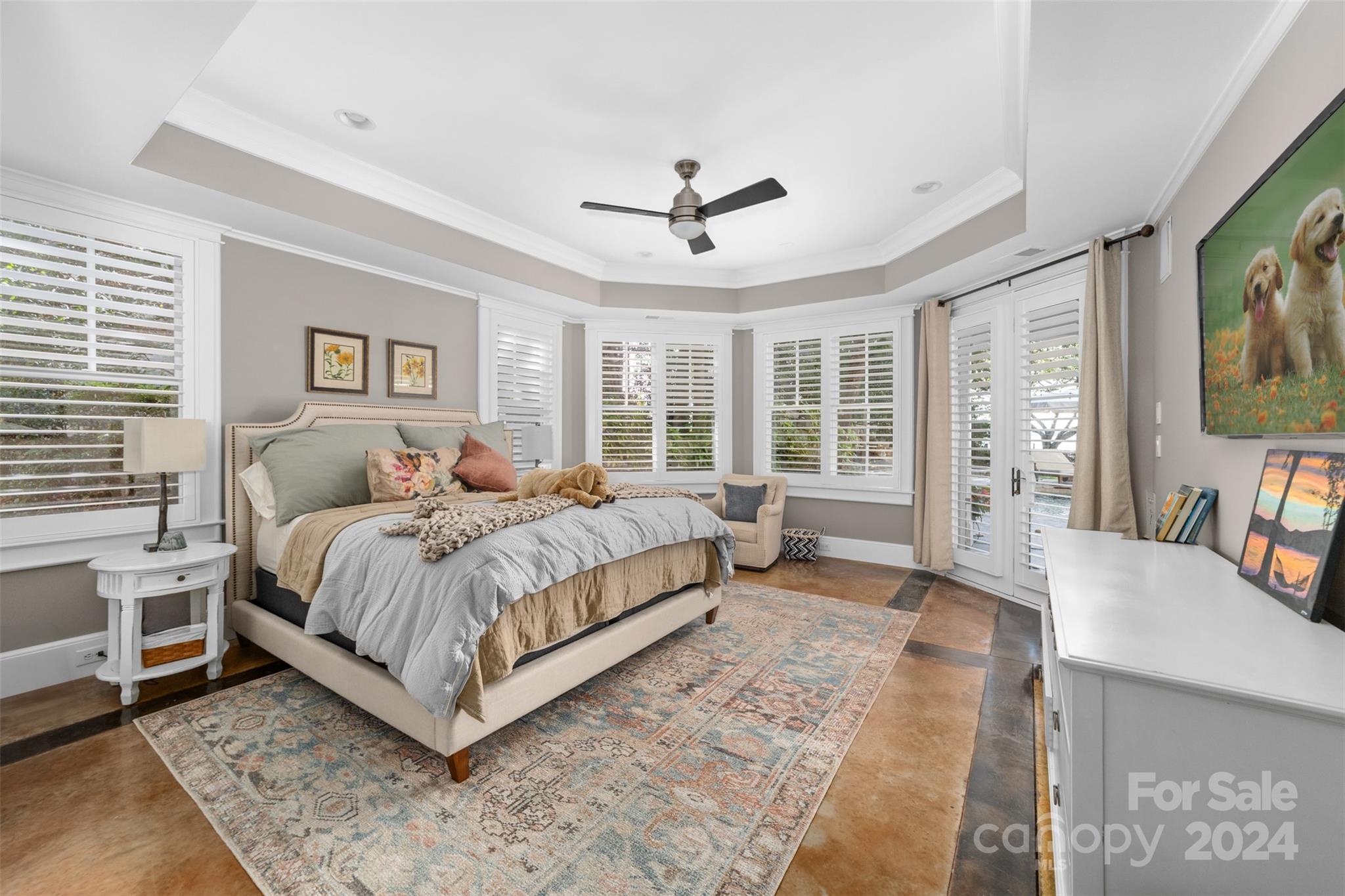 15515 Jetton Road Cornelius, NC 28031 - Photo 32 of 48 a bedroom with a large bed a flat tv screen and a dresser