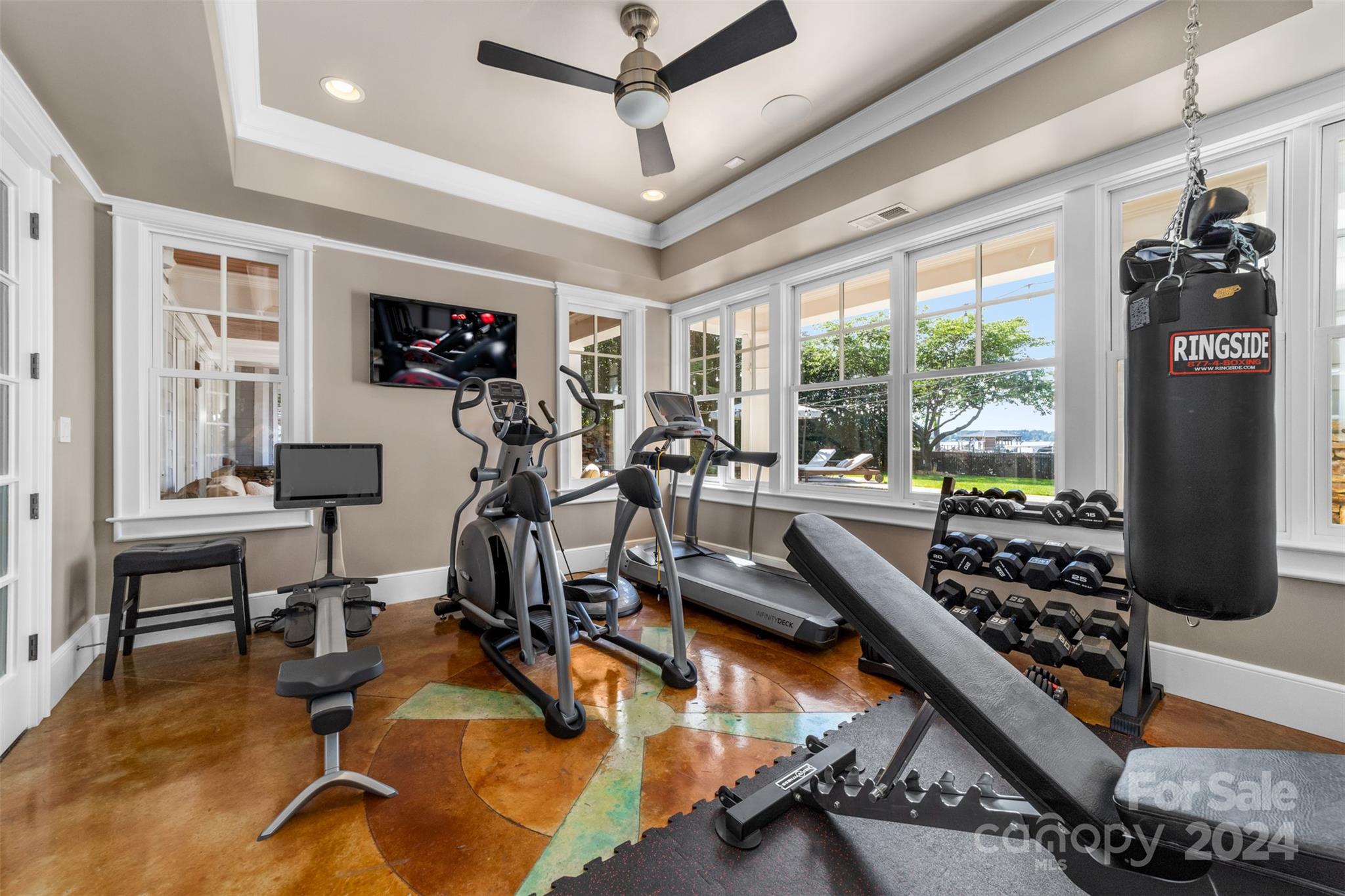 15515 Jetton Road Cornelius, NC 28031 - Photo 38 of 48 a room with gym equipment and windows