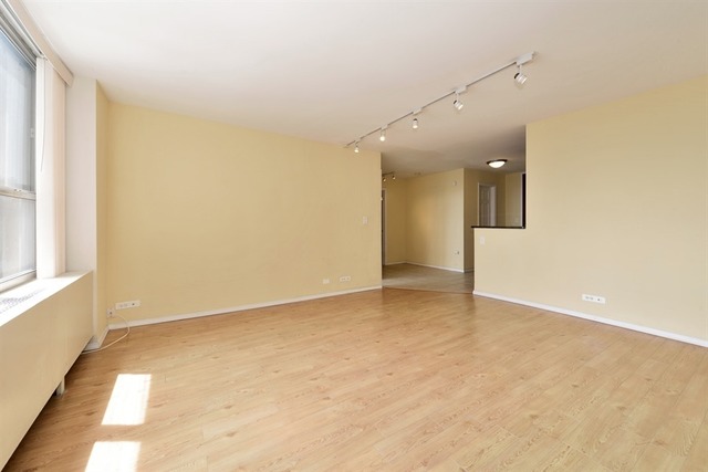 655 West Irving Park Road, Unit 5311 Chicago, IL 60613 - Photo 3 of 10 an empty room with a empty space and windows