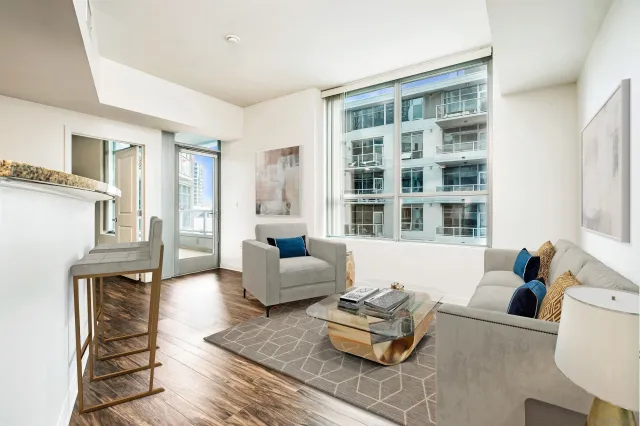 a kitchen with stainless steel appliances granite countertop a refrigerator microwave and wooden floor