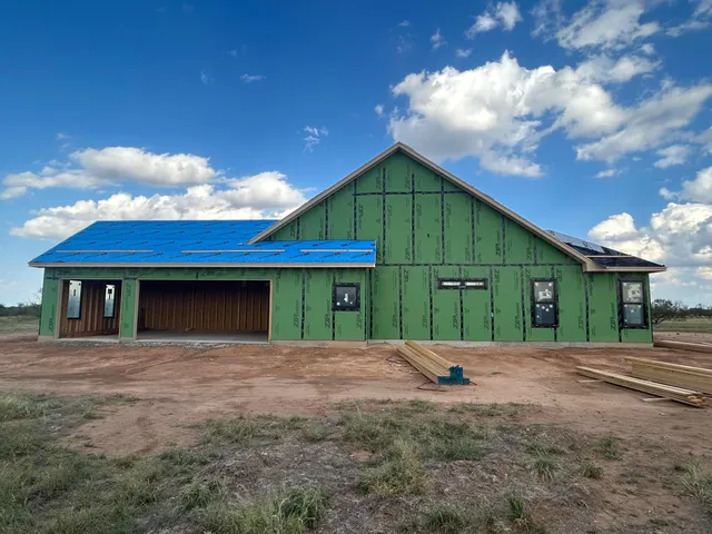 a front view of a house with yard and garage
