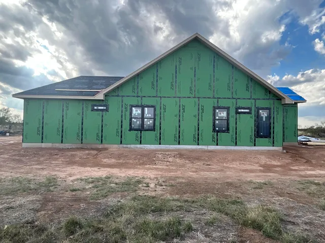 a view of a house with a yard and garage