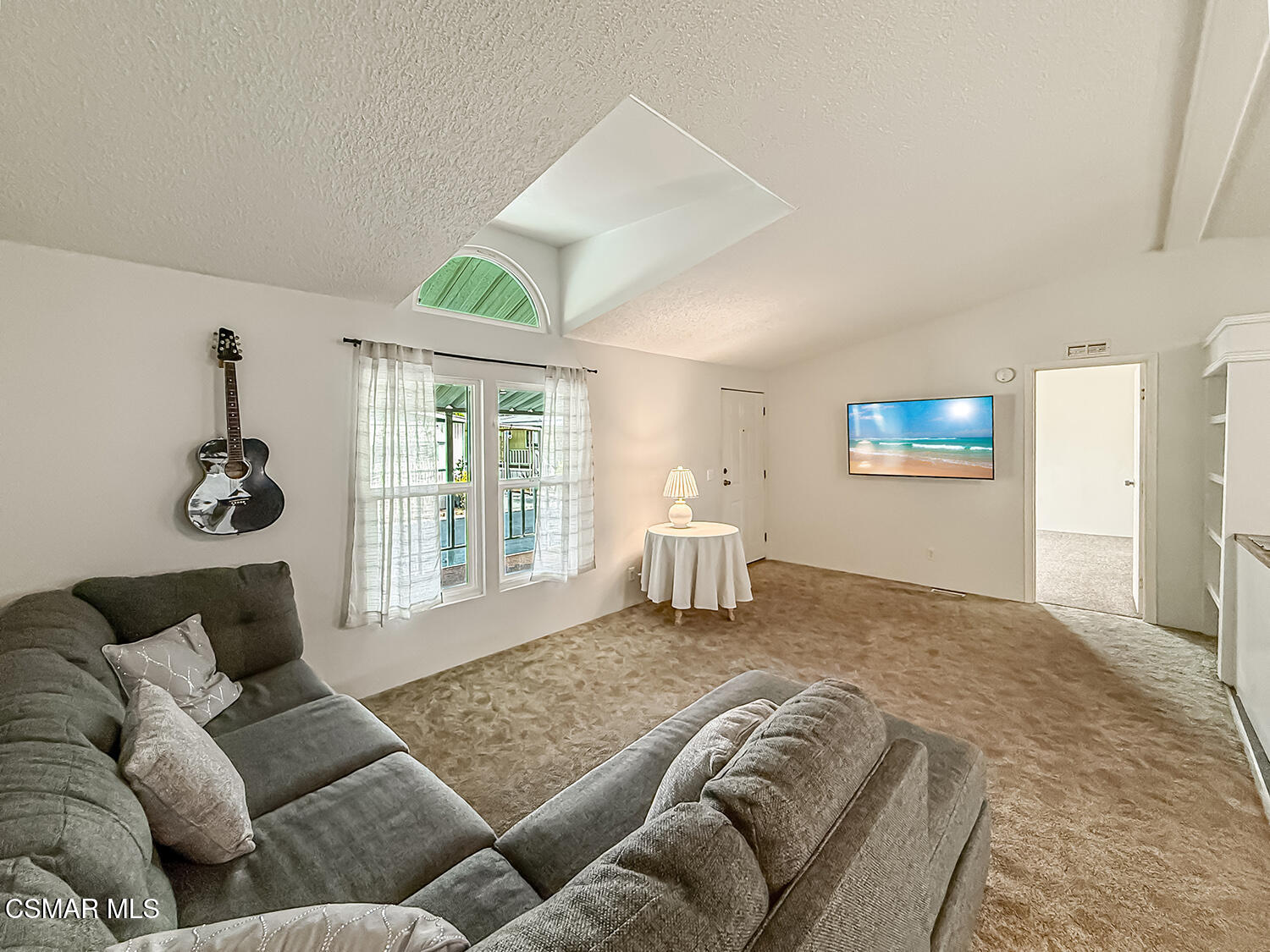 250 East Telegraph Road, Unit 248 Fillmore, CA 93015 - Photo 13 of 42 a spacious bedroom with a bed a couch and a window