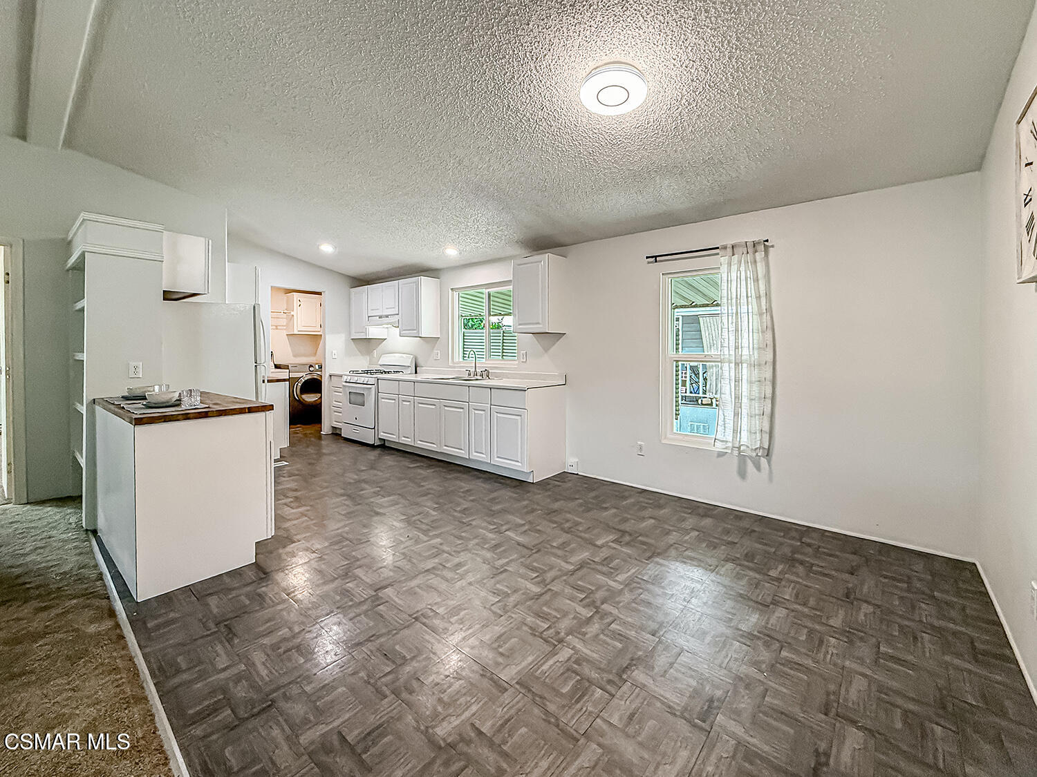250 East Telegraph Road, Unit 248 Fillmore, CA 93015 - Photo 5 of 42 a kitchen with refrigerator and cabinets