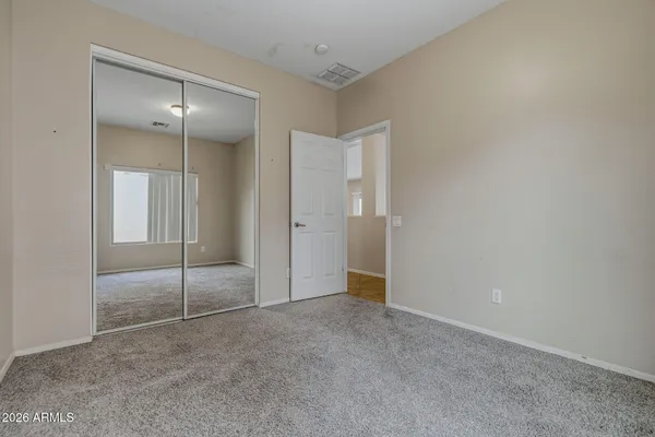 a view of an empty room with closet area