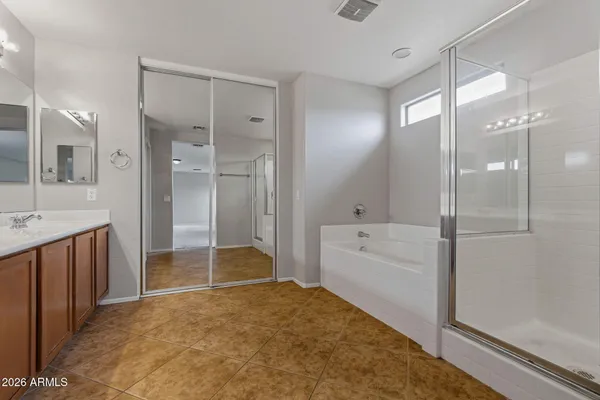 a bathroom with a tub shower and sink