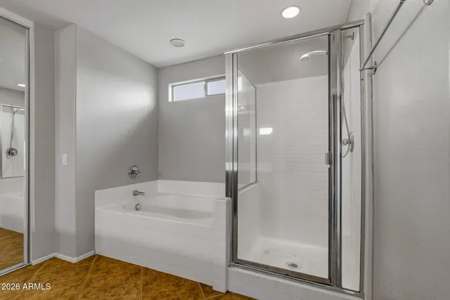 a bathroom with a bathtub and a shower