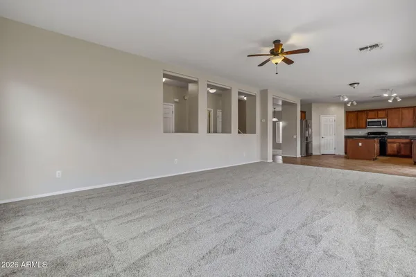 a view of a livingroom with furniture and chandelier fan
