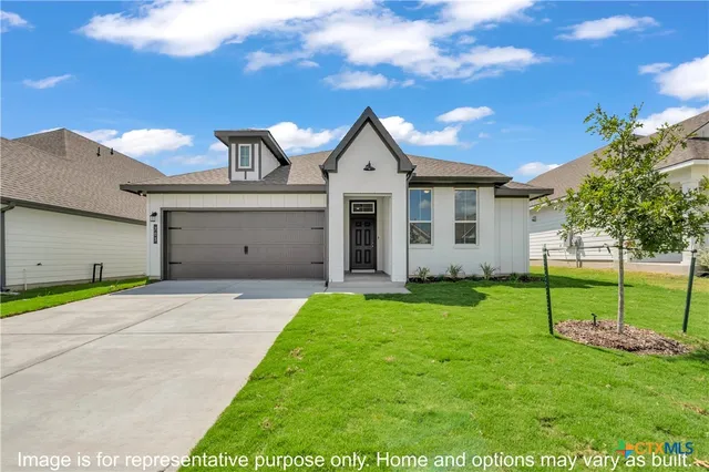 a front view of house with yard and green space