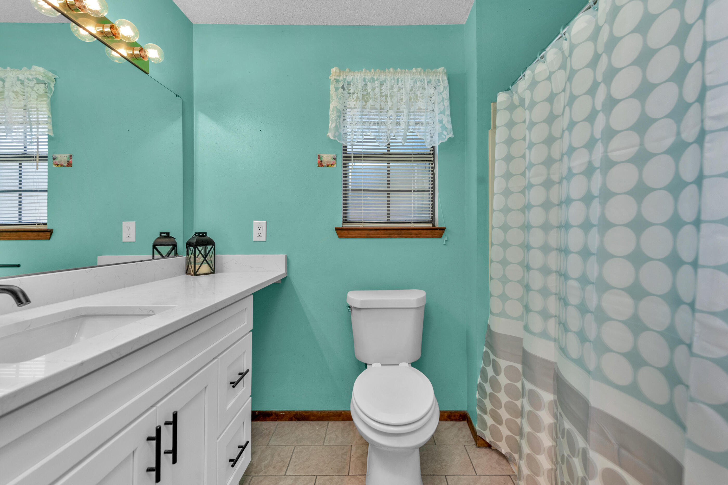 371 Echo Circle Fort Walton Beach, FL 32548 - Photo 19 of 36 a bathroom with a sink a toilet and mirror