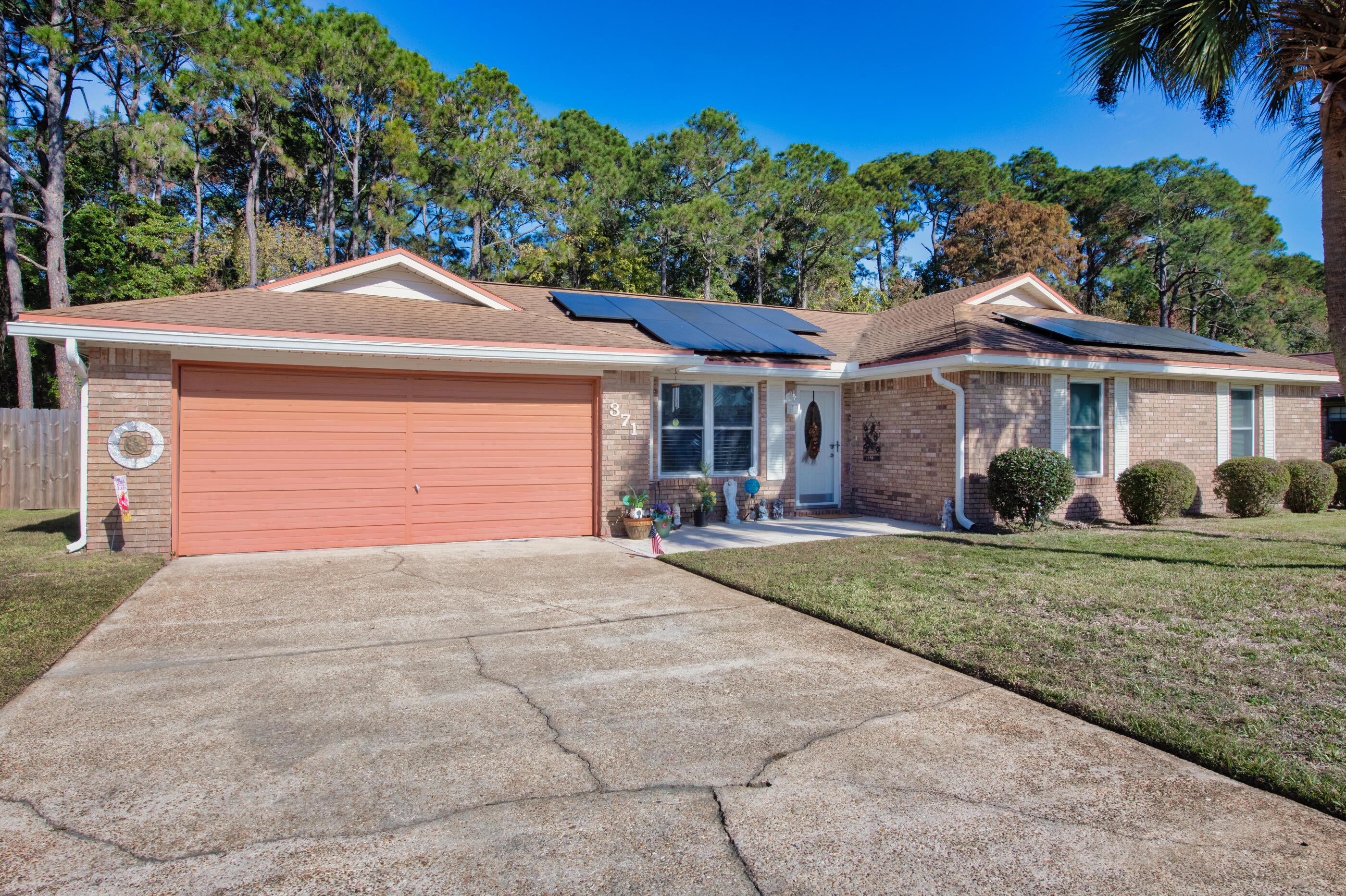 371 Echo Circle Fort Walton Beach, FL 32548 - Photo 24 of 36 a front view of a house with a yard and potted plants