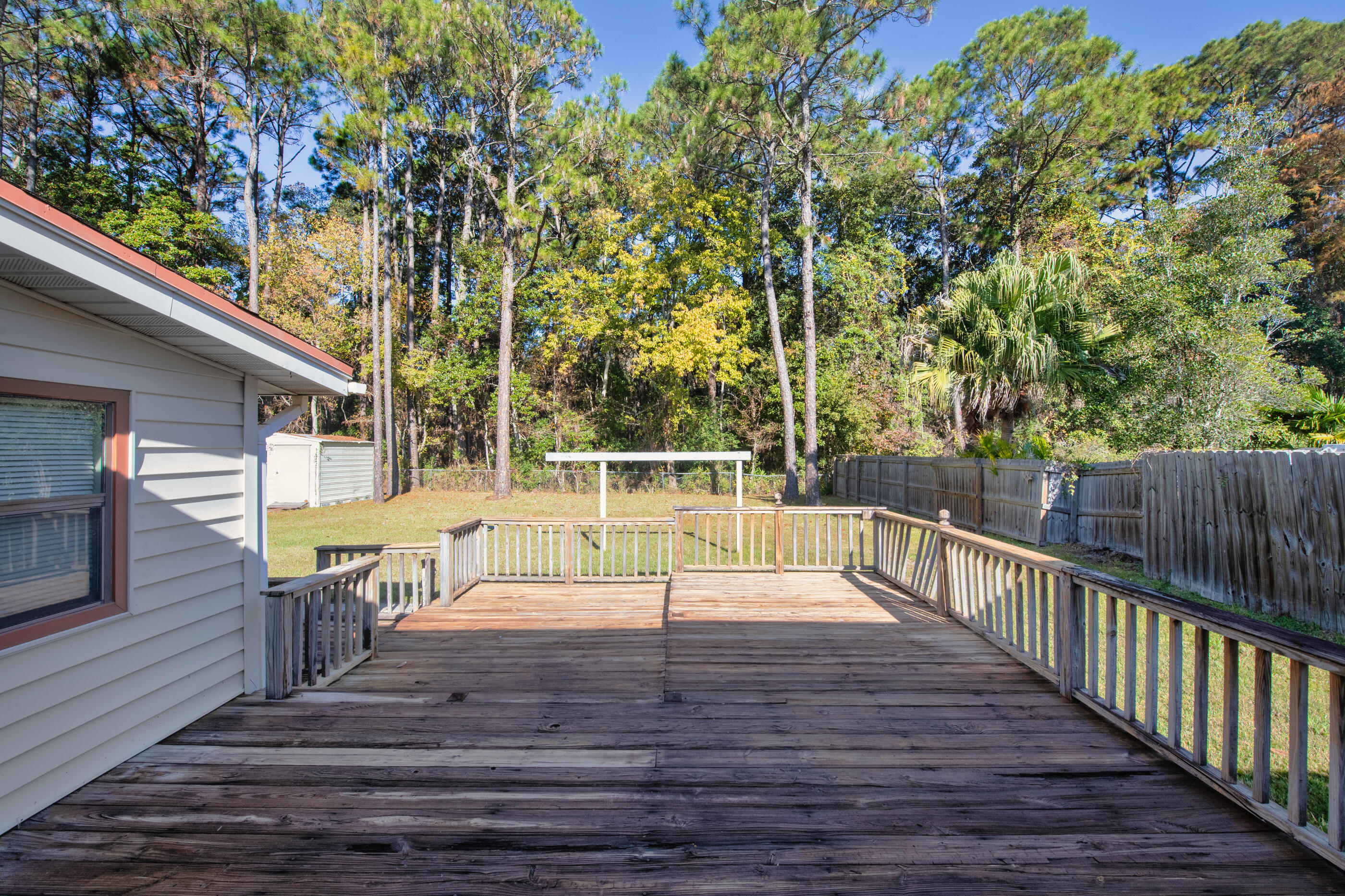 371 Echo Circle Fort Walton Beach, FL 32548 - Photo 26 of 36 a view of a deck with chairs and wooden fence