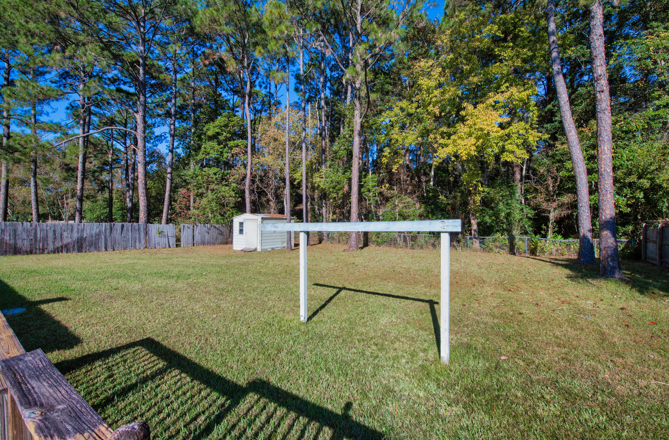 371 Echo Circle Fort Walton Beach, FL 32548 - Photo 29 of 36 a view of a white house with a backyard