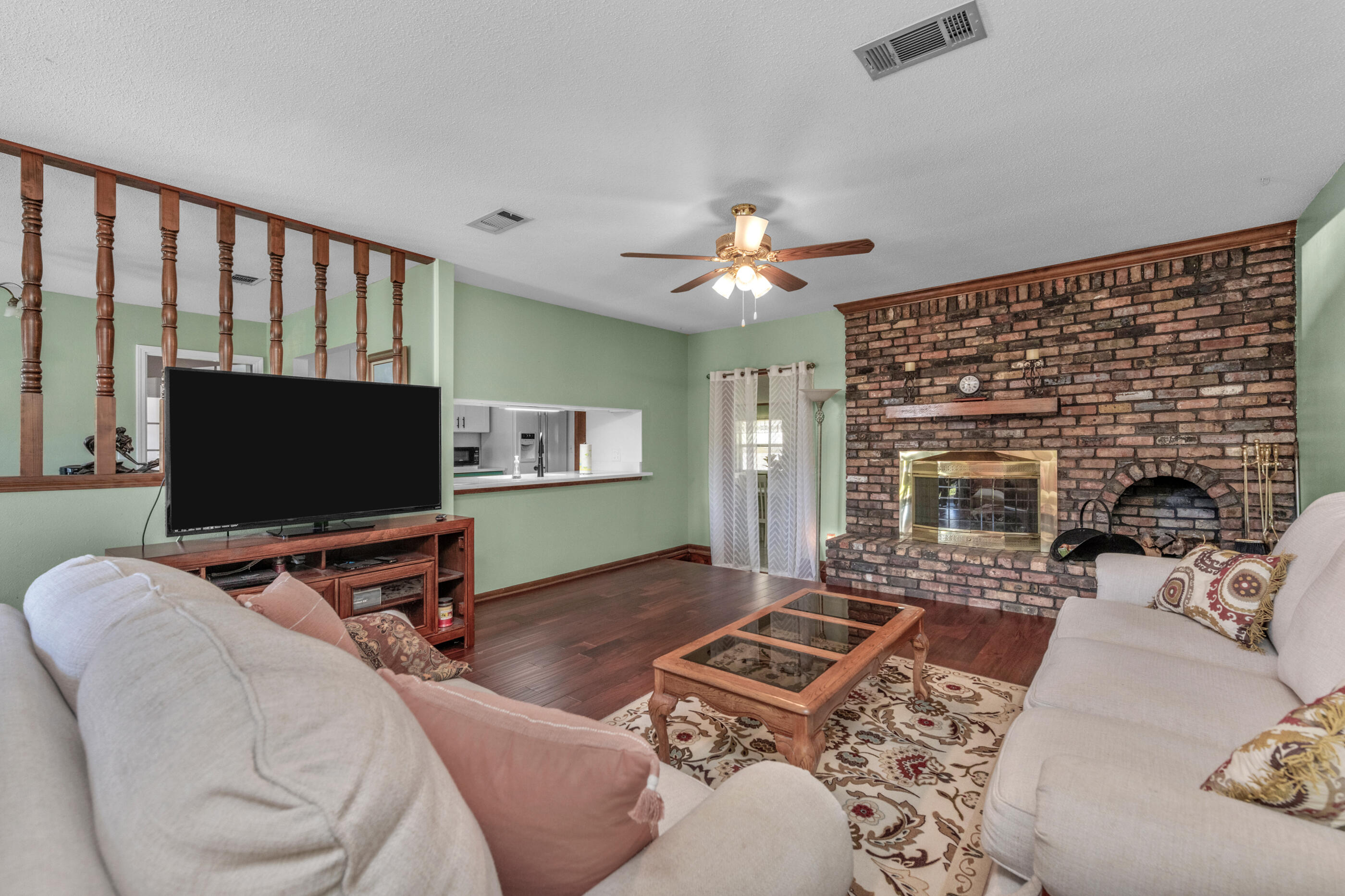 371 Echo Circle Fort Walton Beach, FL 32548 - Photo 3 of 36 a living room with furniture and a flat screen tv