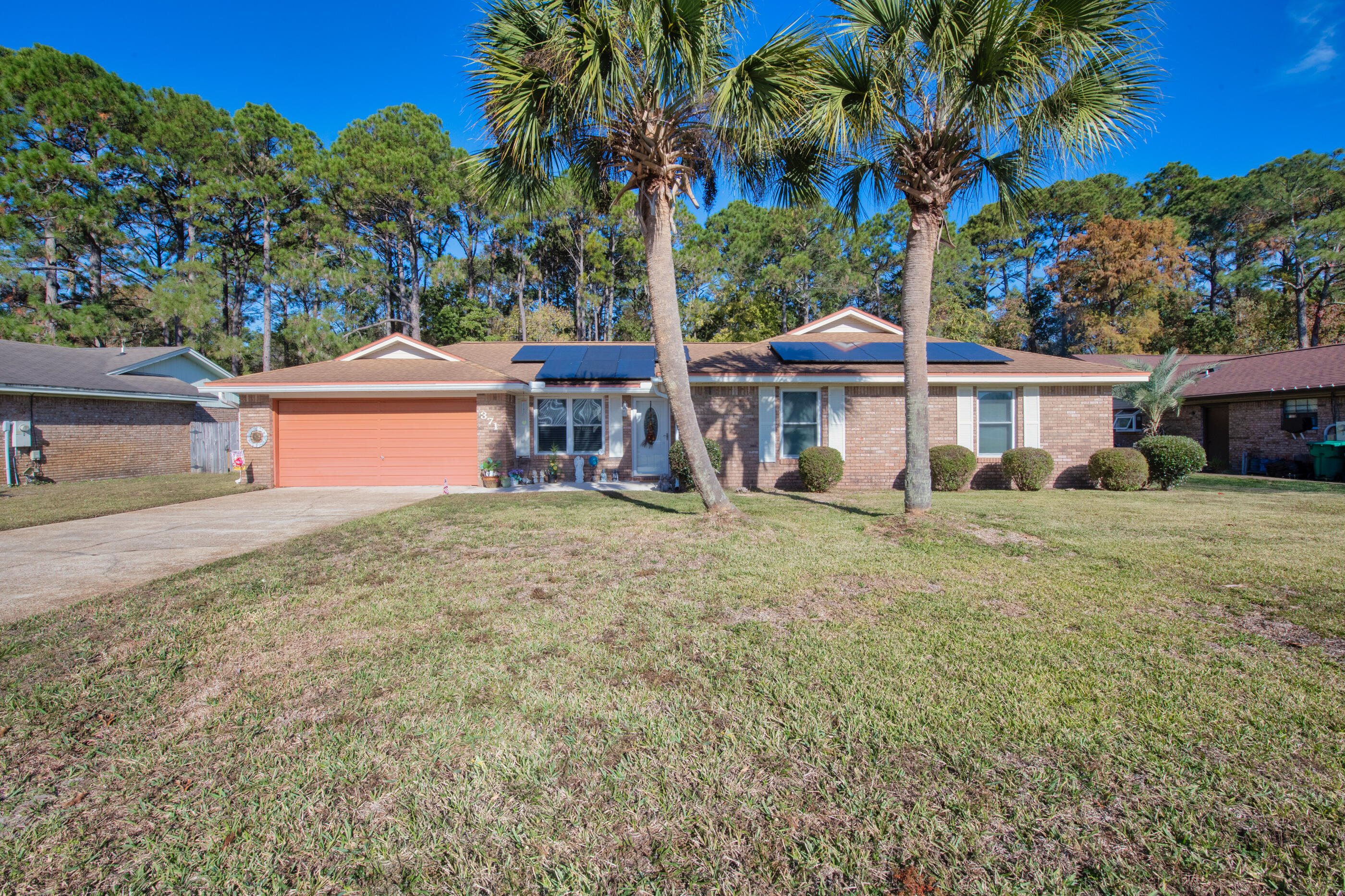 371 Echo Circle Fort Walton Beach, FL 32548 - Photo 34 of 36 a front view of a house with a garden and yard