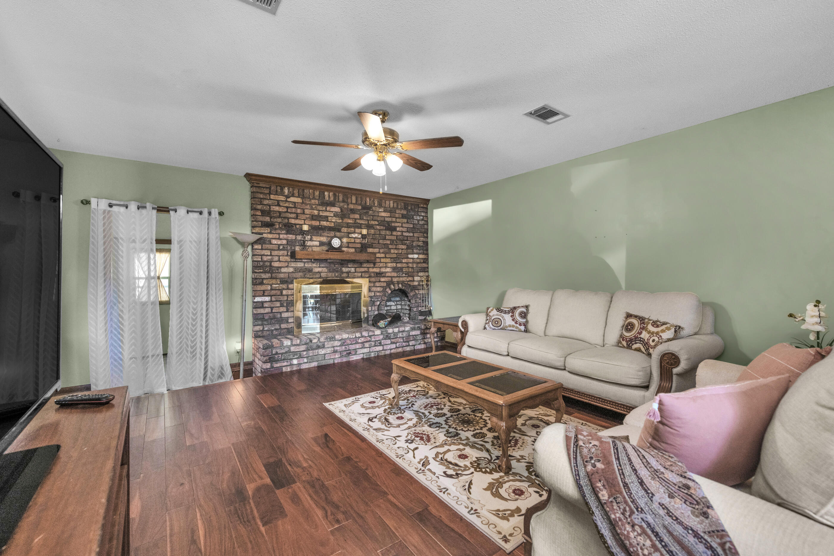 371 Echo Circle Fort Walton Beach, FL 32548 - Photo 4 of 36 a living room with furniture and a fireplace