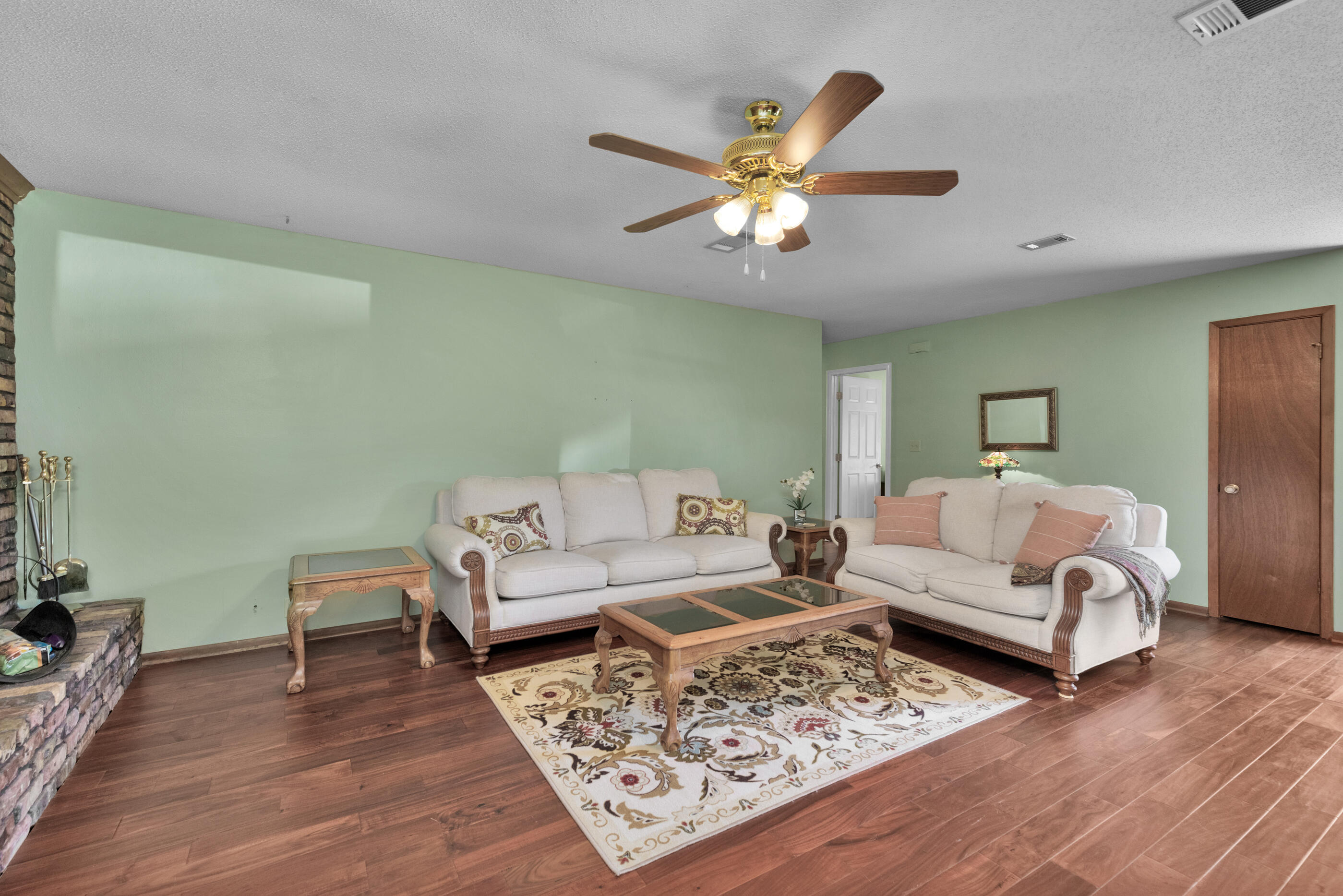 371 Echo Circle Fort Walton Beach, FL 32548 - Photo 5 of 36 a living room with furniture and wooden floor