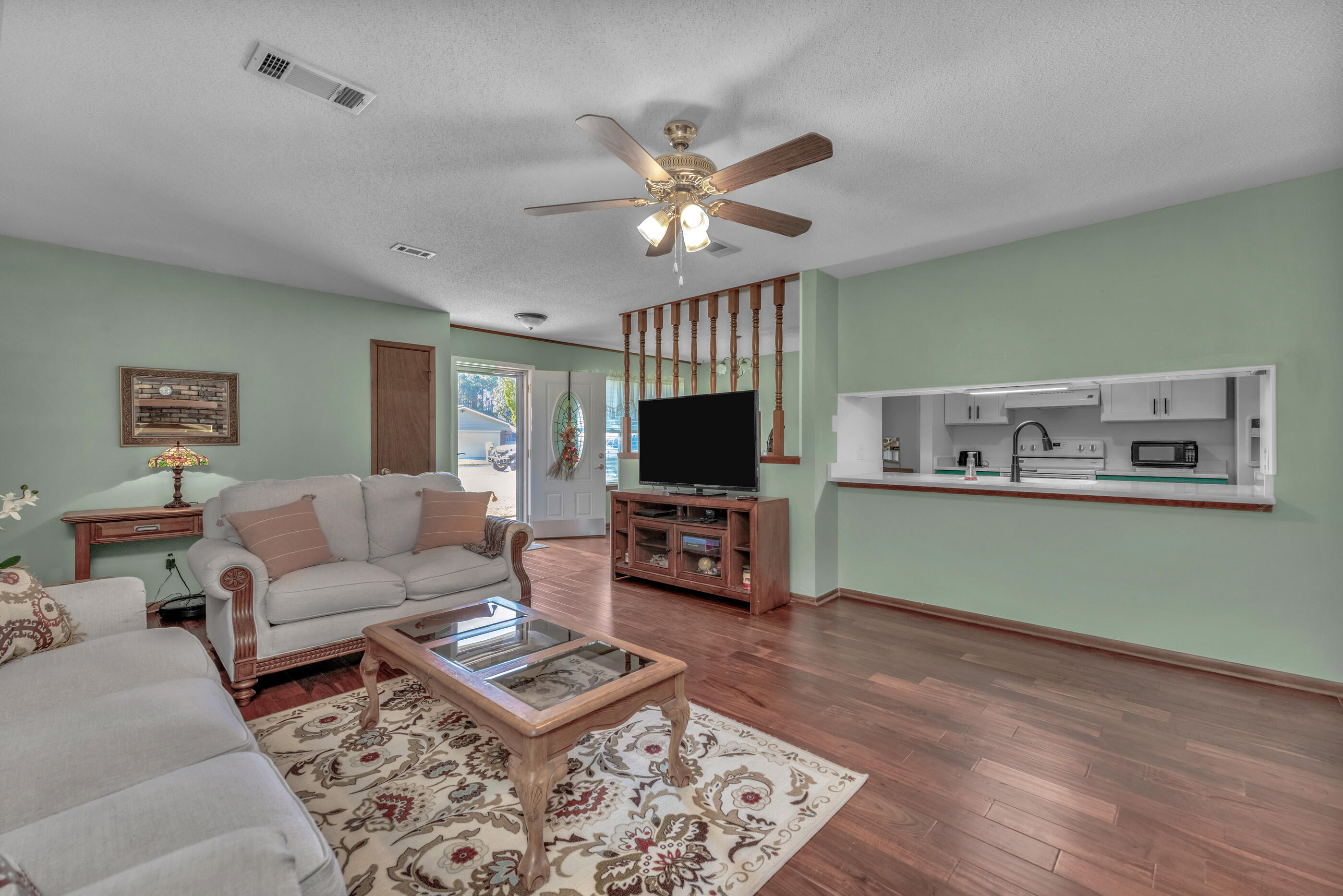 371 Echo Circle Fort Walton Beach, FL 32548 - Photo 6 of 36 a living room with furniture and a flat screen tv
