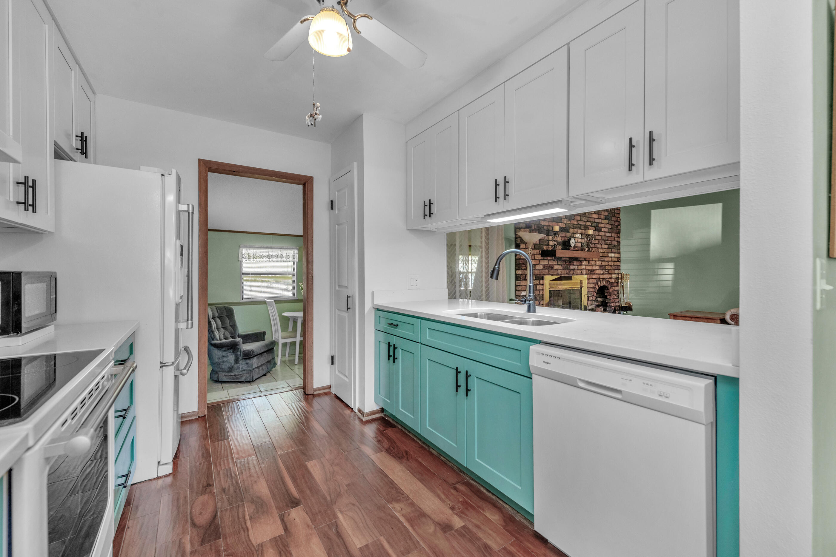 371 Echo Circle Fort Walton Beach, FL 32548 - Photo 9 of 36 a kitchen with white cabinets and wooden floor