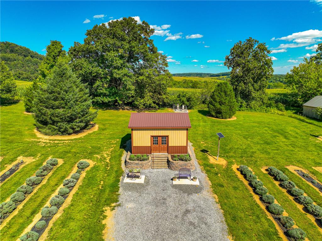 63 Long Road Lenhartsville, PA 19534 - Photo 23 of 100 An outbuilding sits amidst cultivated gardens on a vast, scenic country property.