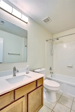 a bathroom with a sink toilet a mirror and shower