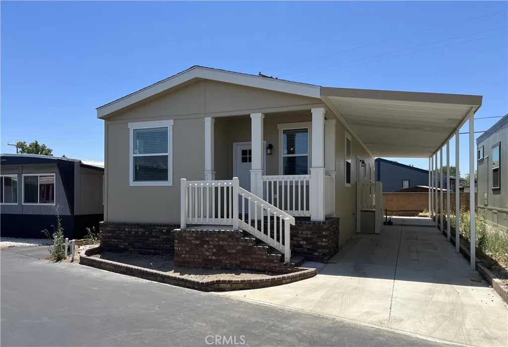 301 East Foothill Boulevard, Unit 59 Pomona, CA 91767 - Photo 2 of 9 a front view of a house with a garage